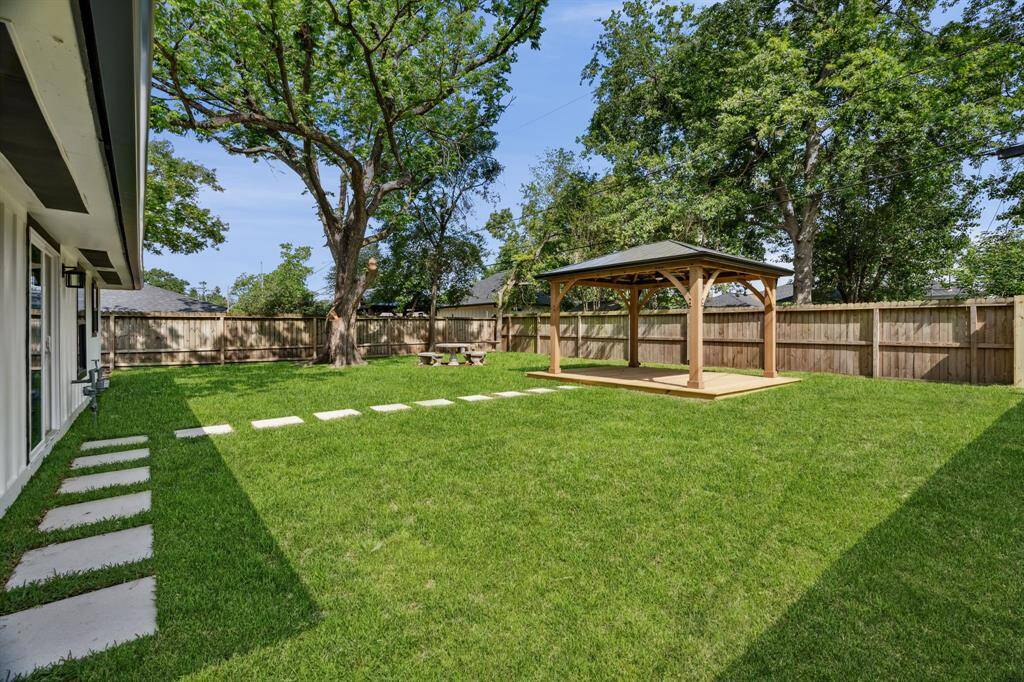 Expansive backyard with brand new sod, mature trees, and space to truly spread out.