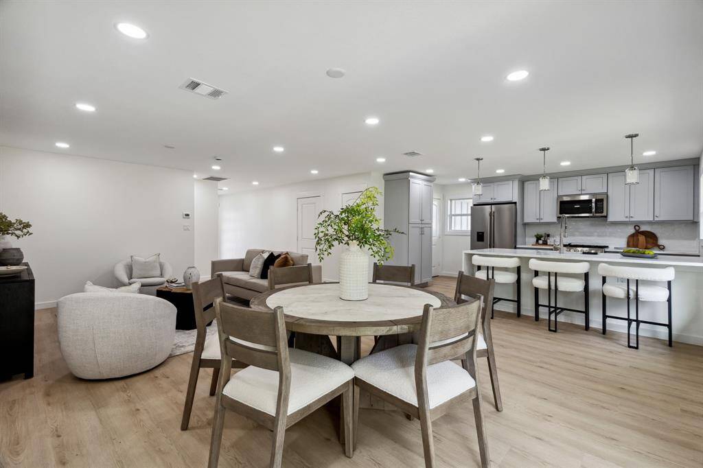 Spacious and bright with recessed lighting and warm-toned flooring throughout.