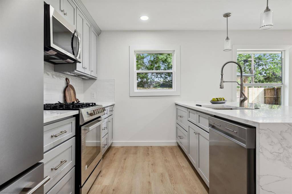 Stainless steel appliances, soft-close cabinetry, and thoughtful window placement.