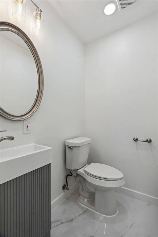 Tucked away powder room with modern fixtures