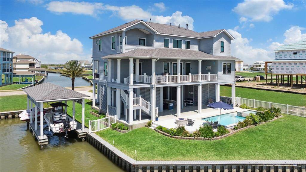 Welcome to your coastal retreat! Enjoy waterfront luxury with a 40-foot boathouse including a boat lift and double jet ski lift. Fish under the stars with a 400W underwater fishing light and lighted Trex bulkhead cap to light the way & evening ambiance. The best of bayside living, enjoy your 25’ x 12’ swimming pool with a gas-heated spa, and relax by the custom gas fire pit after a day on the water