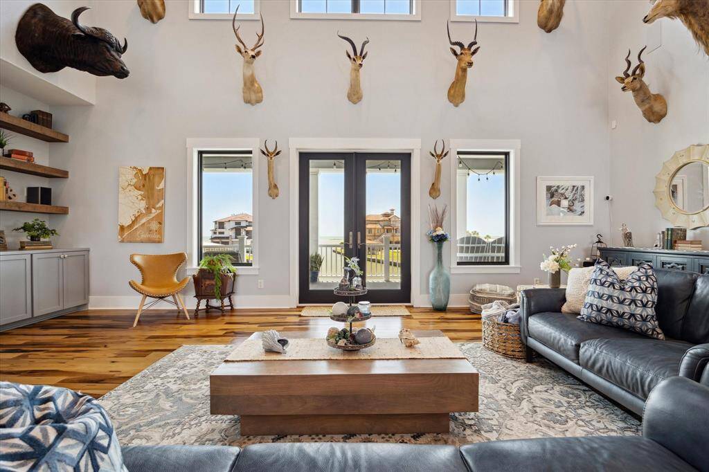 The main living area  offers a stunning vantage point with expansive windows that frame serene water views. Flooded with natural light, the space features an open, airy layout that seamlessly blends comfort and elegance. Whether you're relaxing on the sofa or entertaining guests, the tranquil water backdrop creates a peaceful, ever-changing panorama just beyond the glass