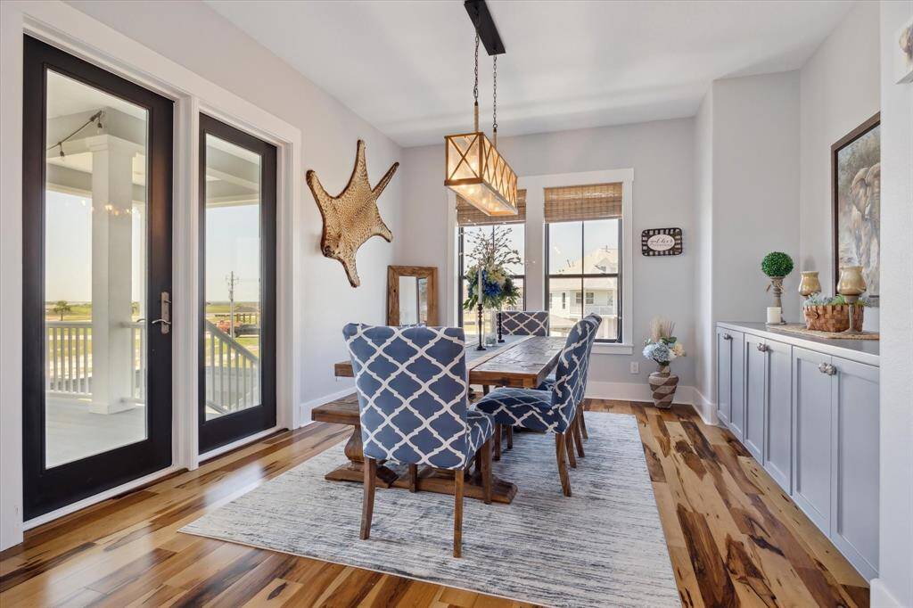The dining area is designed for both elegance and functionality, featuring custom built-in cabinets for storage and display. It seamlessly connects to a spacious balcony, perfect for entertaining guests or enjoying your favorite meals with stunning views
