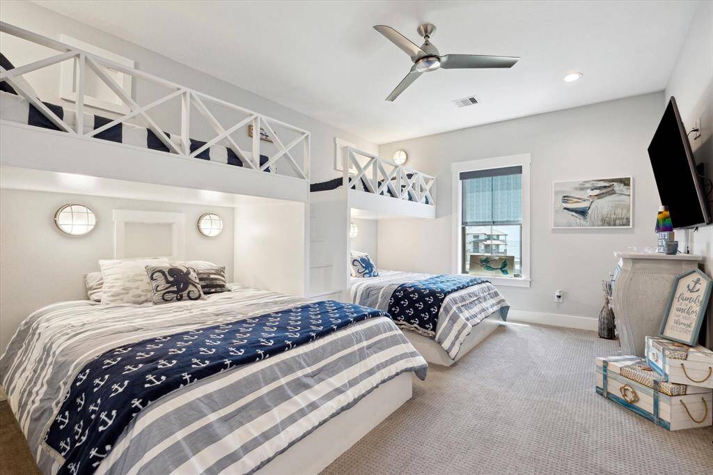 Custom-built twin-over-queen bunks with integrated lighting and tech boxes make this space a dream for kids or visiting guests..SO FUN