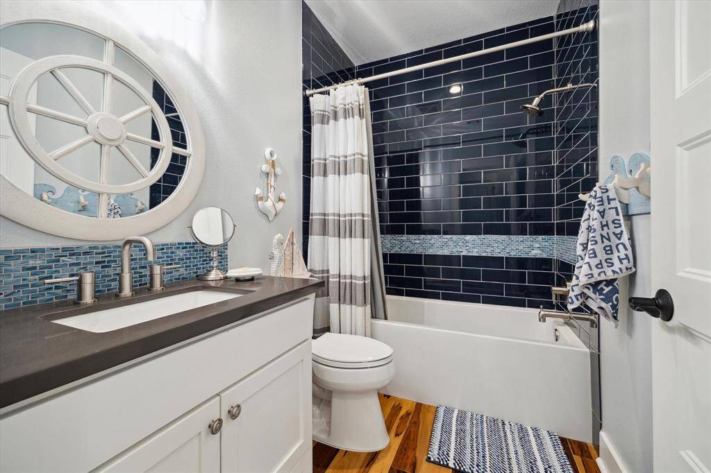 The third bathroom is delightfully nautical including a tub & shower combo