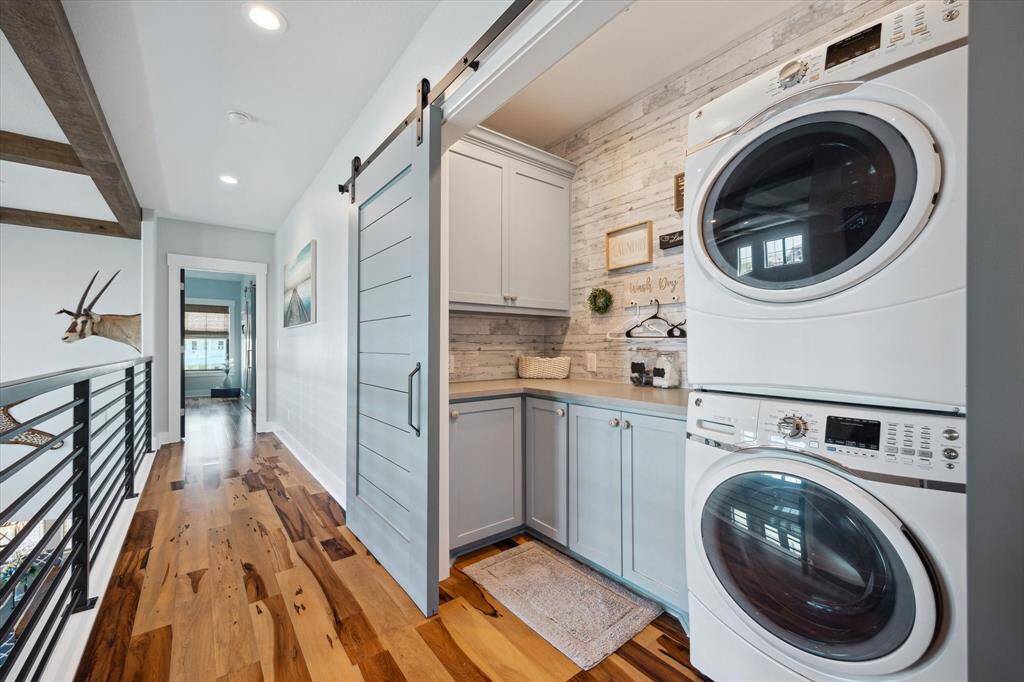 A stylish utility space with custom sliding barn doors adds both function and charm
