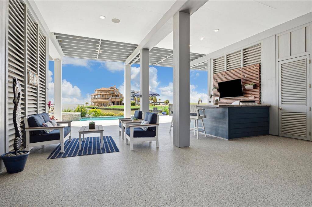 This stunning covered outdoor living area is the ultimate in coastal living—designed for entertaining, relaxing, and taking in the view