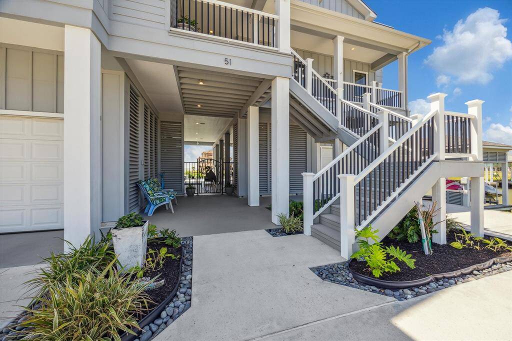 Well manicured landscaping lines the pathway, guiding you to the broad entry staircase that leads to the main entrance—or take a turn and head to the inviting dockside living space on the ground level