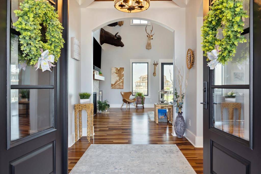 The custom entry sets the tone for this stunning coastal retreat, where breezy elegance and seaside charm welcome you the moment you step inside