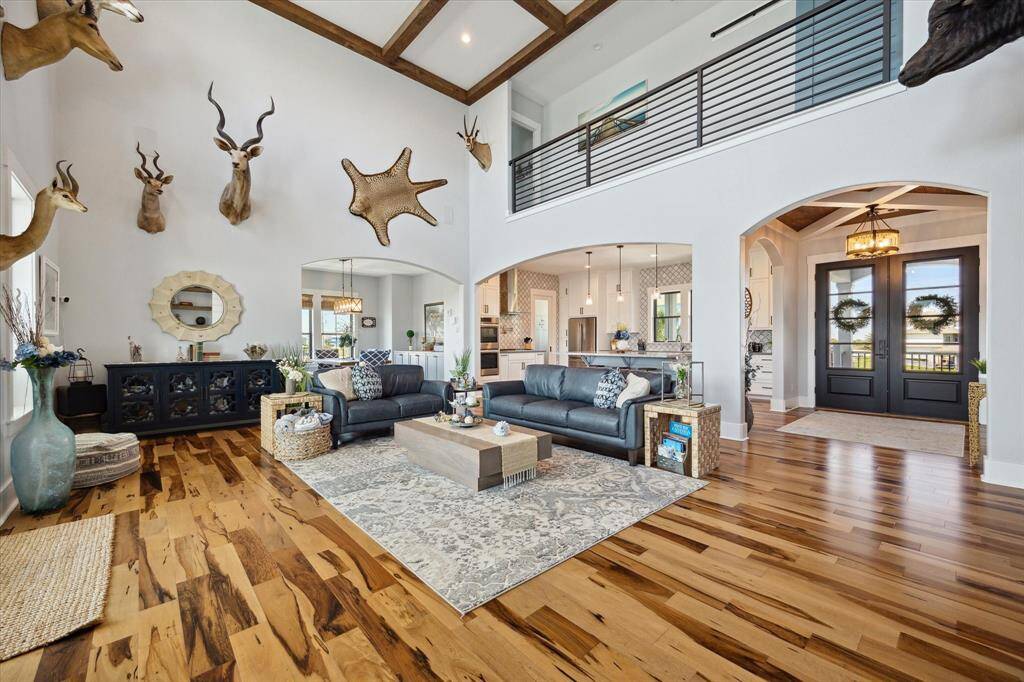 A striking custom entry ceiling sets the tone the moment you walk in. The open foyer provides convenience and style, while Brazilian Pecan engineered hardwood floors carry you throughout the home in rich elegance. Access every level with ease thanks to the in-home elevator—perfect for convenience and accessibility