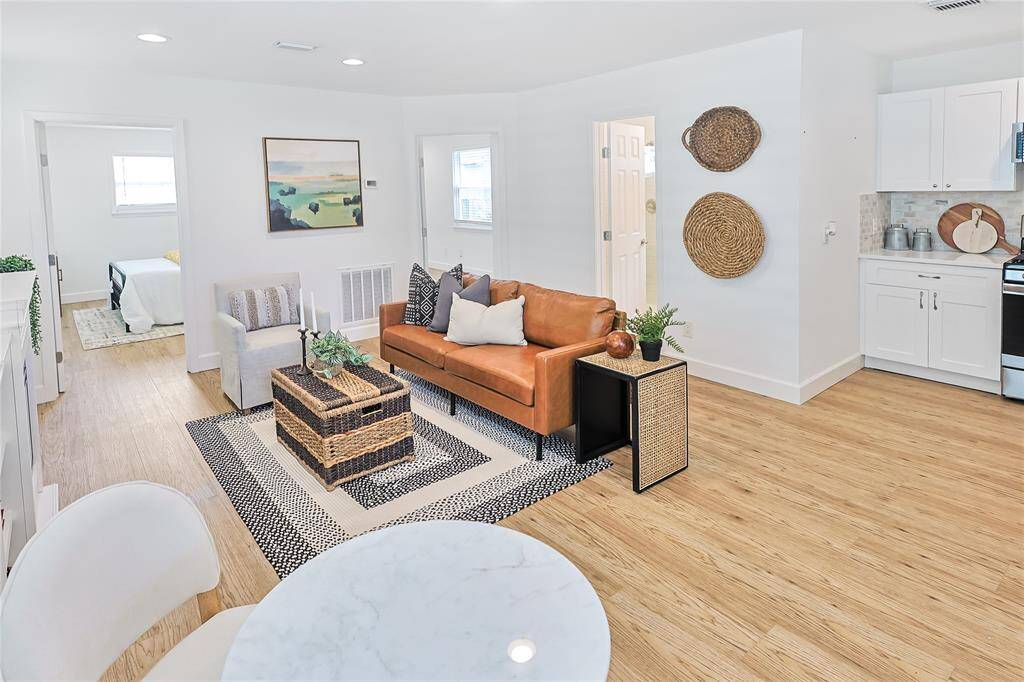 The gorgeous living room is spacious, bright and open- with this gorgeous flooring throughout!
