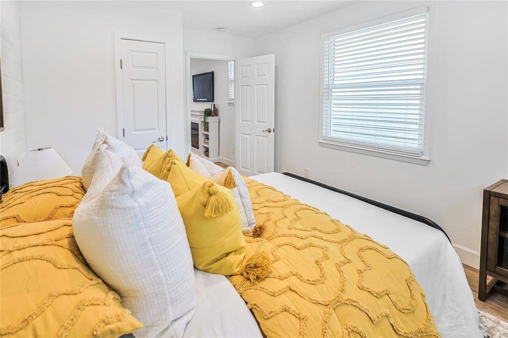 Bright and spacious! This room offers plenty of natural light and a built-in cabinet for added convenience and storage.
