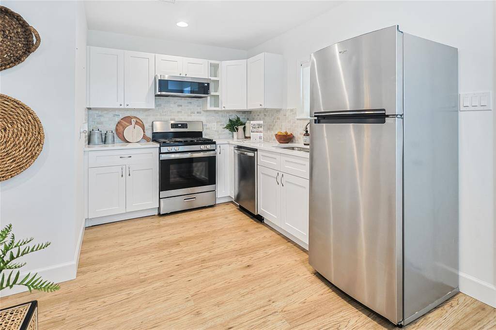 The updated kitchen provides ample storage, modern finishes and stainless steel appliances.