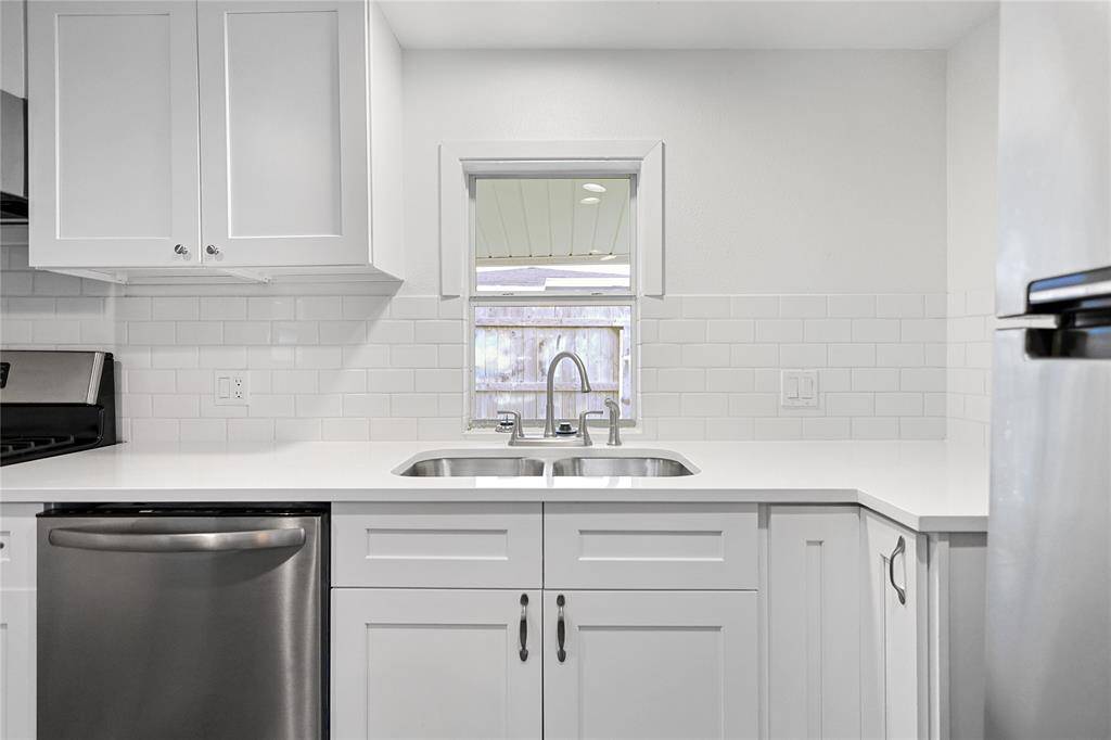 Gorgeous quartz countertops and subway tile backsplashes in this updated kitchen space for those who like a bit of style with their utility.