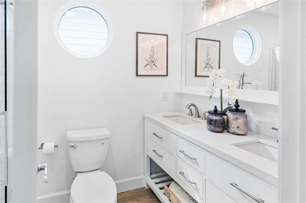Modern fixtures and double-sink vanity makes this bathroom a dream.