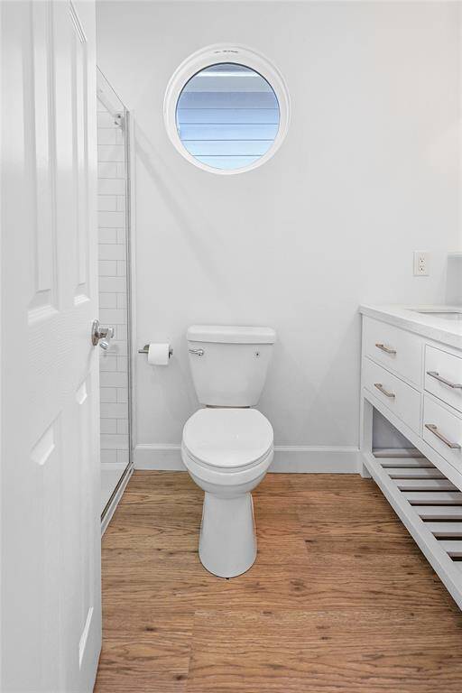 The porthole-style window gives a touch of charm in this updated bathroom.
