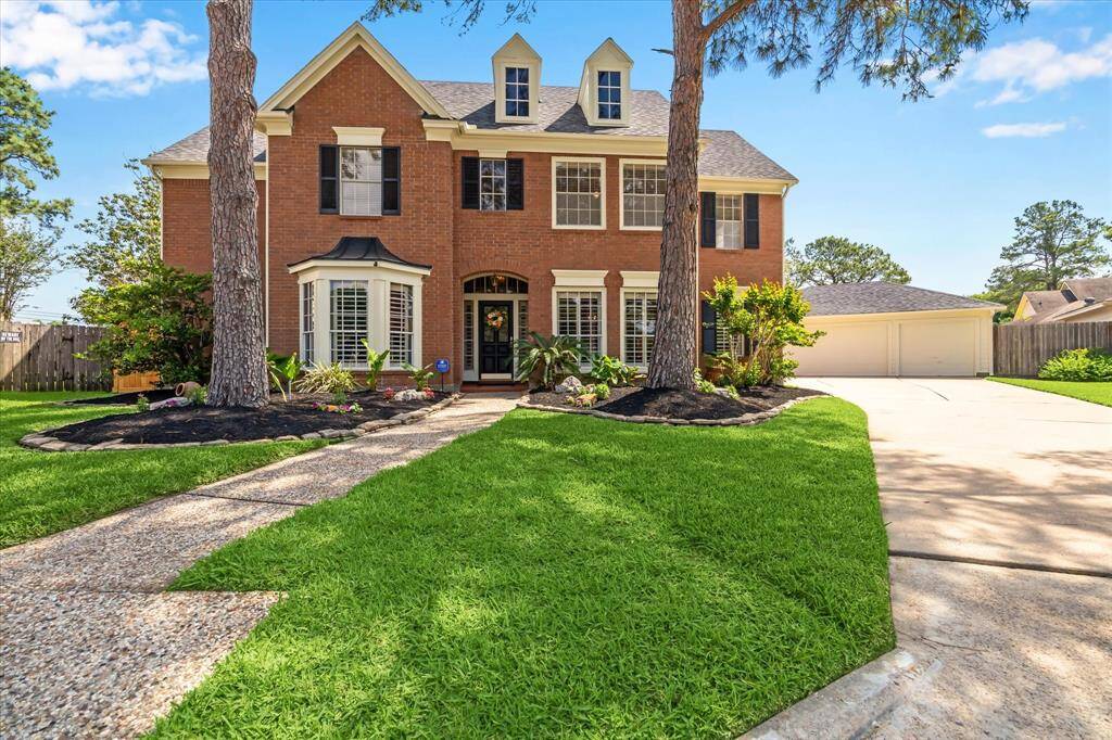 This stately two-story home stands out with its freshly painted front door, shutters, and trim—giving the exterior a crisp, welcoming look that complements the home's timeless charm.
