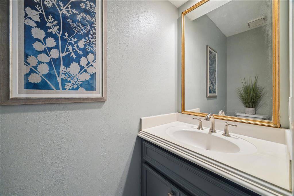 A conveniently located half bath on the first floor offers comfort and privacy for guests—thoughtfully tucked away for easy access without interrupting the flow of the main living space.
