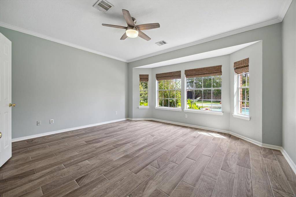 Wood-look tile flows seamlessly throughout the first floor, adding warmth and durability. The spacious primary bedroom offers serene views of the backyard pool—your own private escape just steps away.