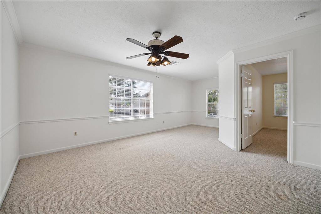 The spacious upstairs game room offers plenty of room for play, movie nights, or lounging, with a cozy alcove at the end of the hall—perfect for a reading nook, study space, or additional storage.