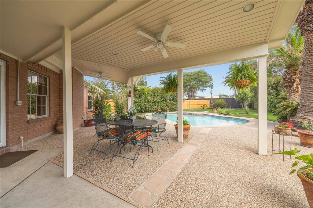 Step outside to the freshly painted covered patio—offering plenty of space for a dining table, grill, and relaxed outdoor living all year round.