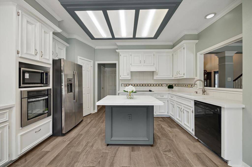 The updated kitchen features brand-new quartz countertops, oven, microwave, and a modern sink, blending fresh style with everyday functionality—perfect for cooking, hosting, and everything in between.
