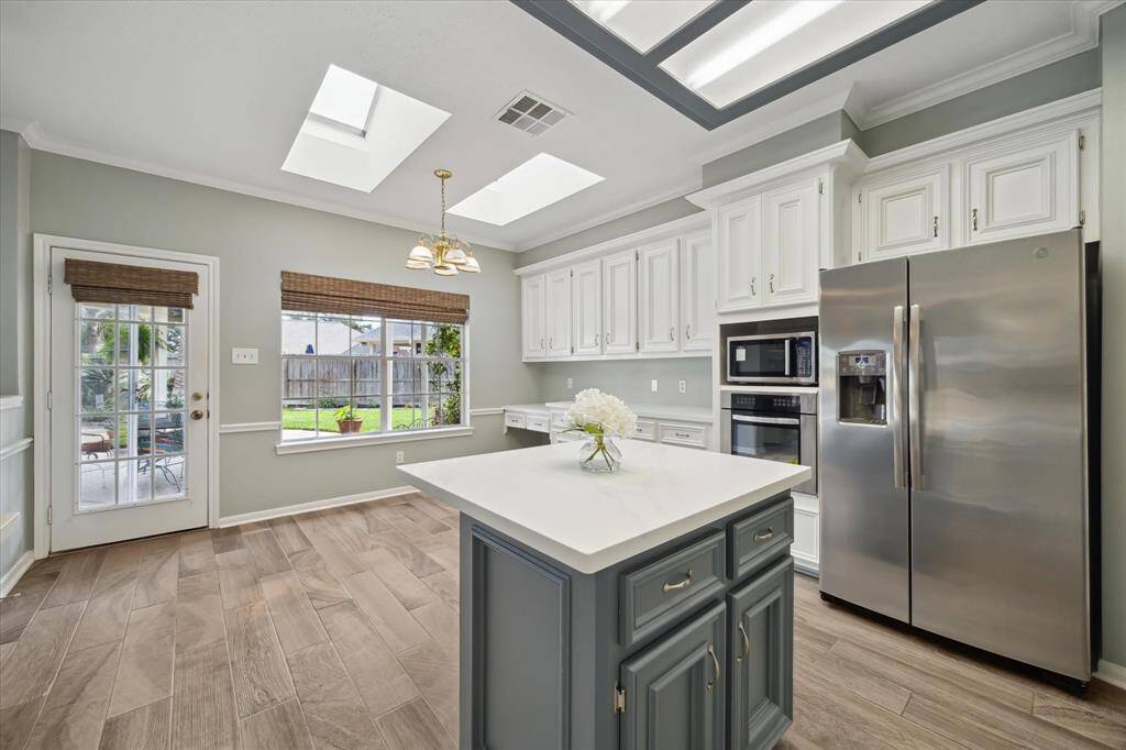 A cozy breakfast nook just off the kitchen offers the perfect spot for morning coffee, with easy access to the back patio and grill area—ideal for indoor-outdoor dining and weekend BBQs.