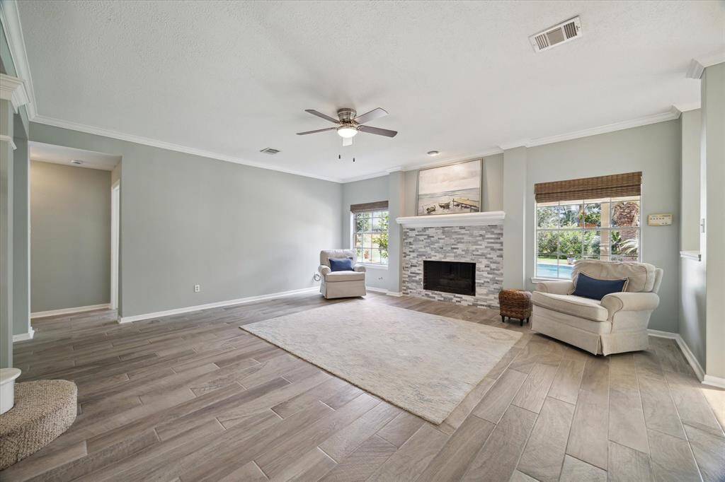 The recently updated fireplace surround adds a fresh focal point to the living area—but the real showstopper is the view of the sparkling pool and lush backyard just beyond. It’s the perfect blend of comfort and wow factor.