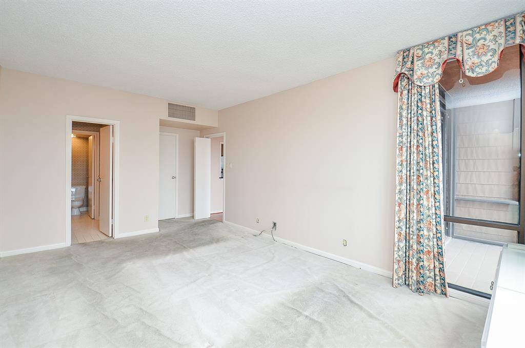 The primary suite is spacious, has balcony access and an en-suite bath.