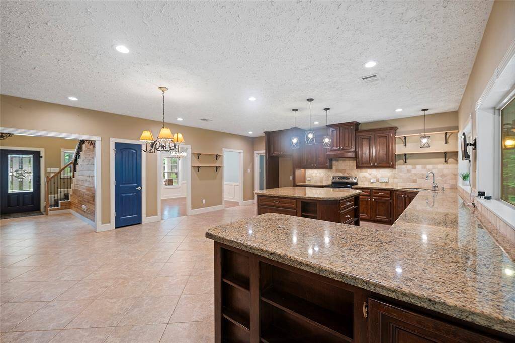 Once you are past the entry, you will come into this GRAND island kitchen! Before we take a look, let's explore the formal dining!