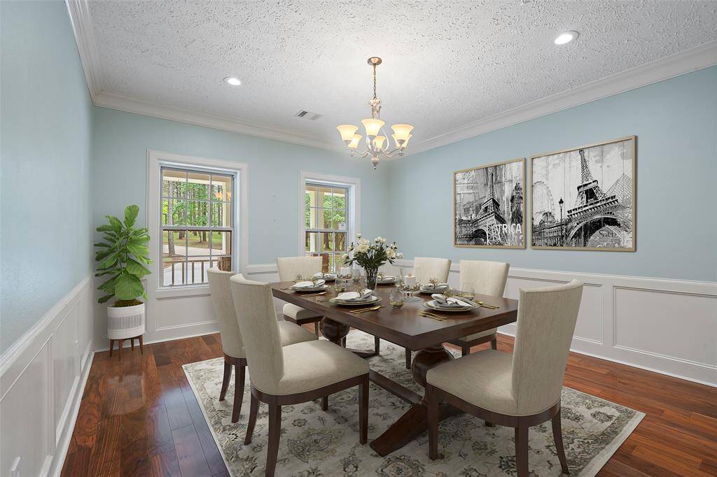A beautiful formal dining room awaits you! Tons of natural light with gorgeous wood flooring, box molding & crown molding makes for a classic dining style, ready for special meals or late-night card games with your guests!
