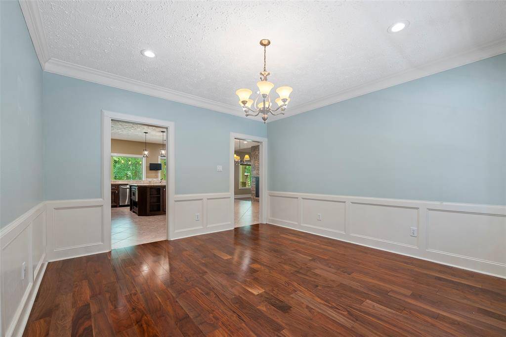 There is also recessed lighting and a pretty chandelier that anchors the space!  The direct access to the kitchen is so convenient when it comes to entertaining!