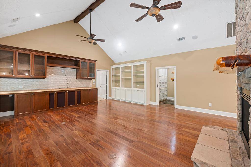 Gorgeous wood flooring, with electrical access to float your furniture and have plugs is so wonderful!  First, let's take a look past the custom built-ins and into the room at your right!