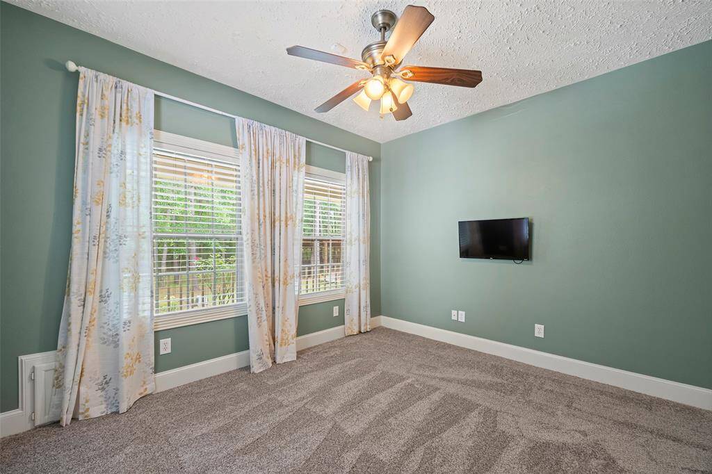 This secondary bedroom is also located on the first floor and has a touch of color that connects with nature and is ready for a new resident to make it their own!