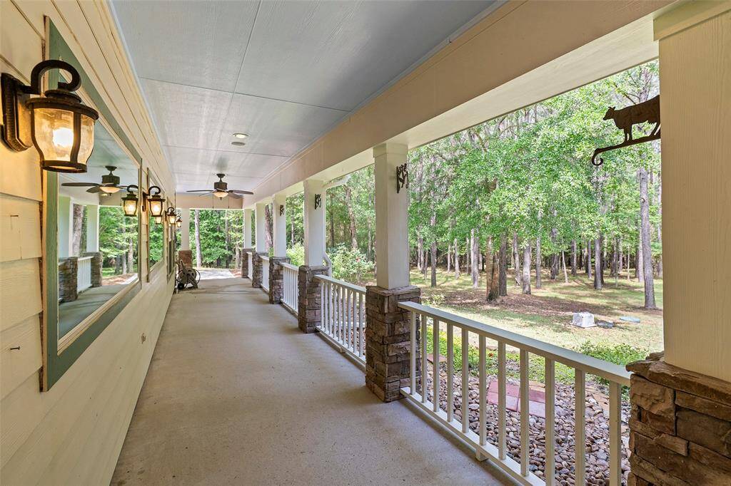 A TEXAS sized covered patio with coach lights, ceiling fans and recessed lighting offers a place to enjoy the great outdoors any time of day!