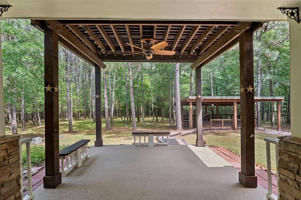 Once you step off the main covered patio, you have this expanded area perched beneath the pergola for even more outdoor enjoyment!  Look at all those trees providing shade and a place for the birds, squirrels and other friends to live and play!
