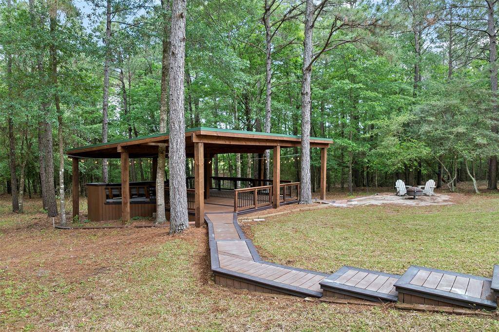 Follow the pathway to another separate covered patio area amongst the trees!