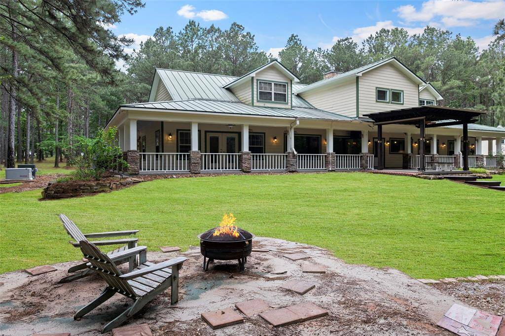 A cozy area away from the home and in a cleared space, makes a place of respite for nights enjoying a firepit looking up at the stars!  We just love the added features of the walkways, the raised stack stoned flowerbed softening the edges of the home, and if you look closely, you will see the Generac that helps keep your home running when the power goes out!