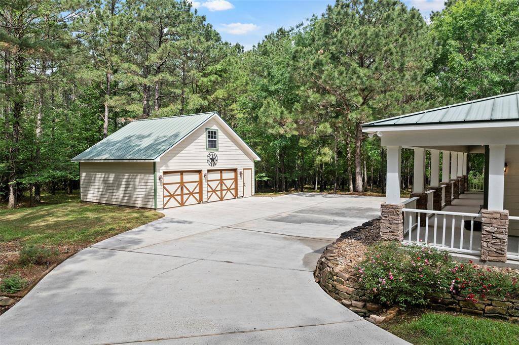 Tucked to the side is this expansive parking area with a 2-car garage with extra storage space! Everything is bigger and grander in Texas!