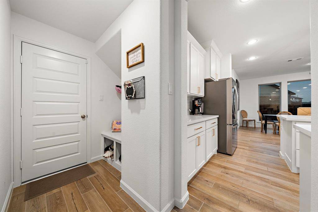 Right off the kitchen is the mud area with storage space.