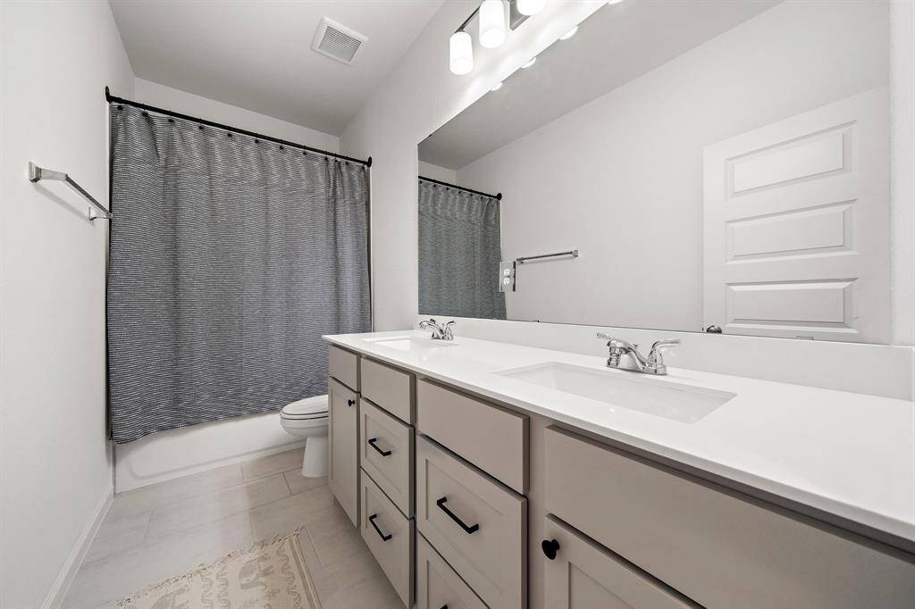 Third bathroom features atub/shower combo and long vanitywith dual sinks and plenty of counter space.