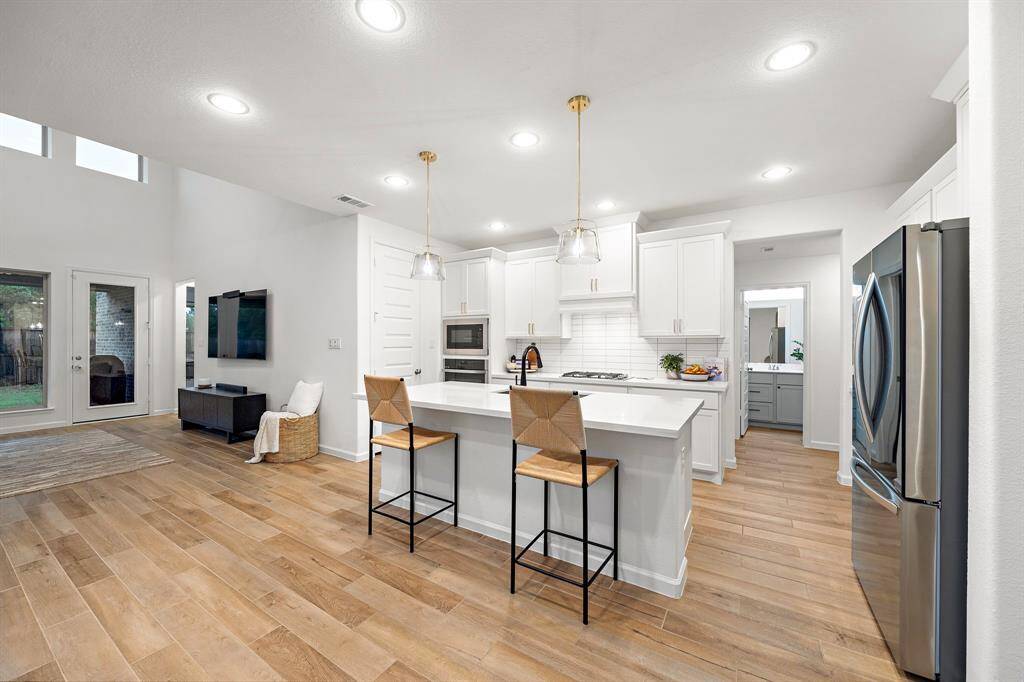 The kitchen, an integral part of thishome's open-concept design,seamlessly flows off the living room,creating a harmonious andconnected living space.