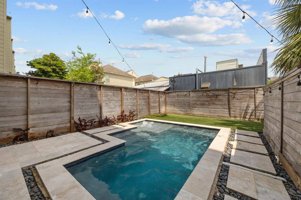 Welcome to your backyard oasis with heated pool at 5212 Lillian