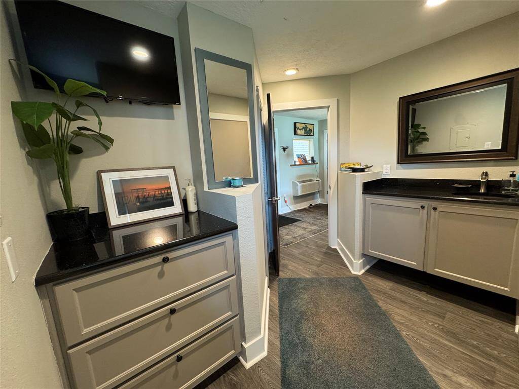 The private bath with sink and separate vanity area with another area dressing