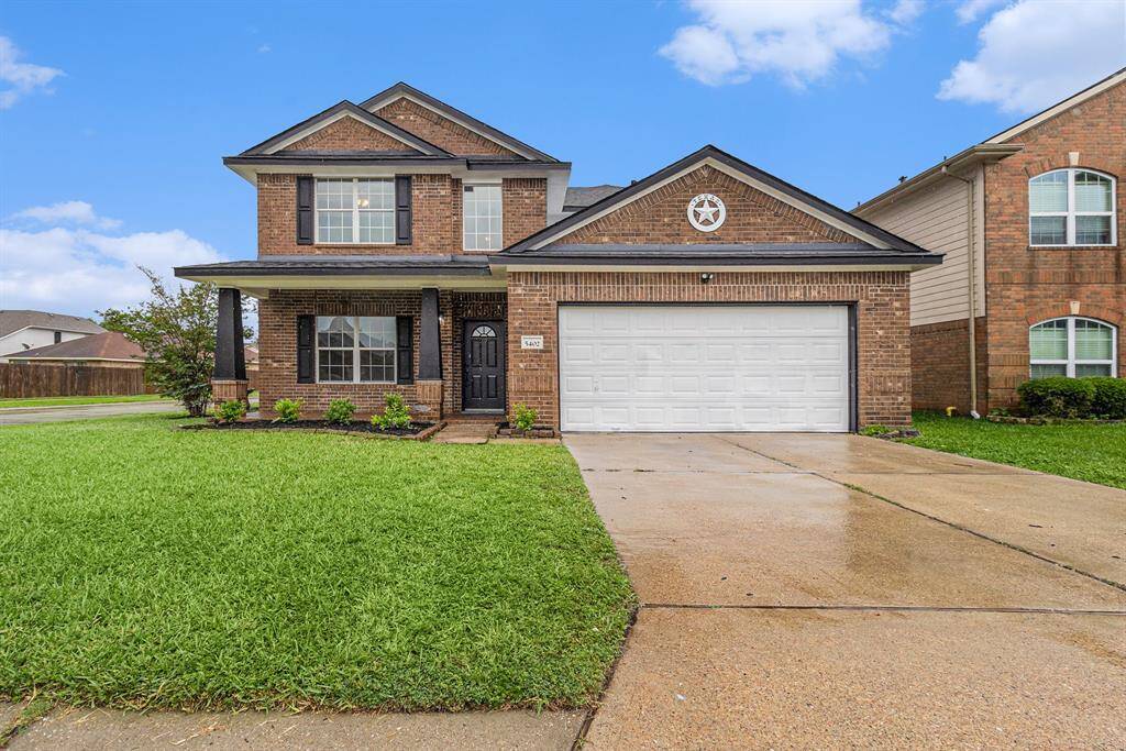 Charming two-story brick home with a well-maintained lawn, two-car garage, and a covered front porch. Ideal for families, located in a suburban neighborhood with nearby amenities.