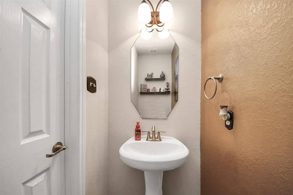 Powder bath is conveniently located on the first floor next to the utility room.