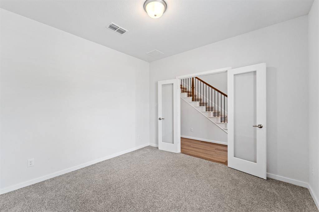 French doors open into a private home office just off the entry, creating an ideal space for productivity and focus.
