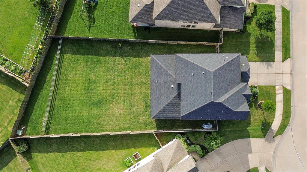 Bird’s-eye view showcases the full lot size, home layout, and privacy fencing on all sides.