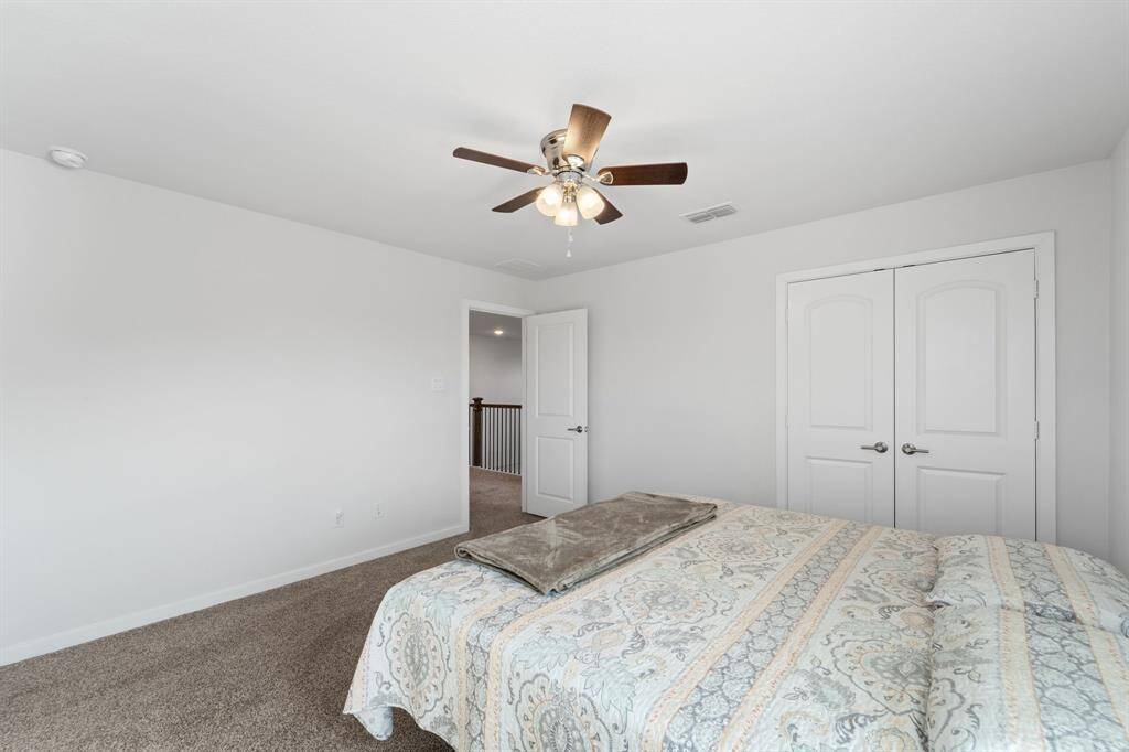 Second view of the upstairs bedroom emphasizing the generous closet and easy hallway access.