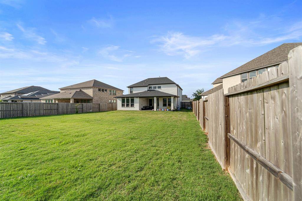 The oversized backyard offers endless possibilities for play, pets, or future customization—fully fenced and surrounded by neighboring privacy.